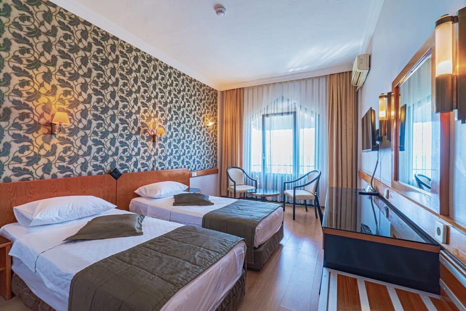 Standard Room, Sea View | Minibar, in-room safe, desk, laptop workspace