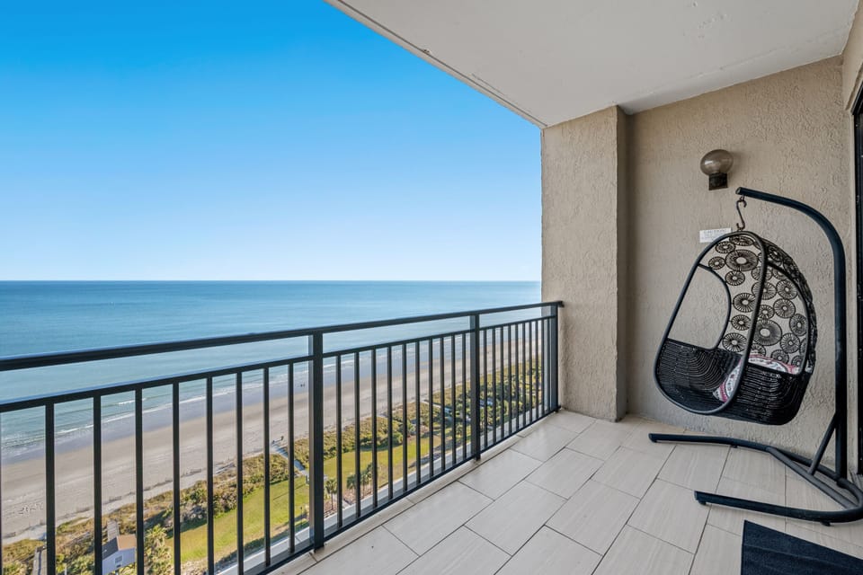 Swing with the breeze and watch the waves crash onto the white sandy beach.