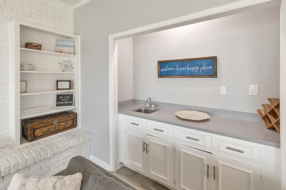 Coastal charm with custom shelving and convenient drink station.