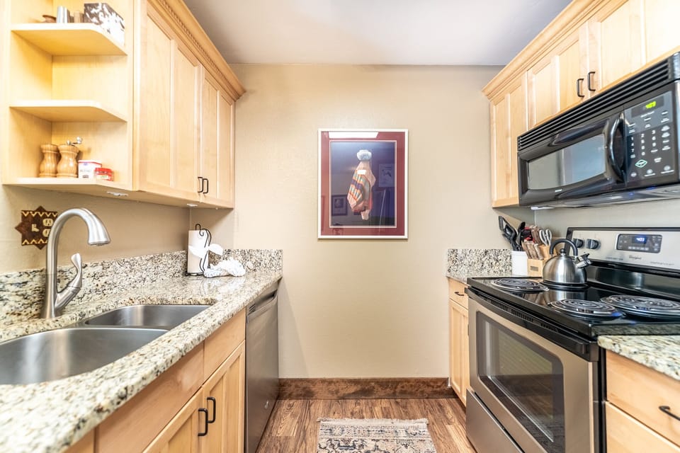 Your fully equipped galley kitchen features granite counters, stainless appliances, and everything you need to prepare delicious meals during your stay.