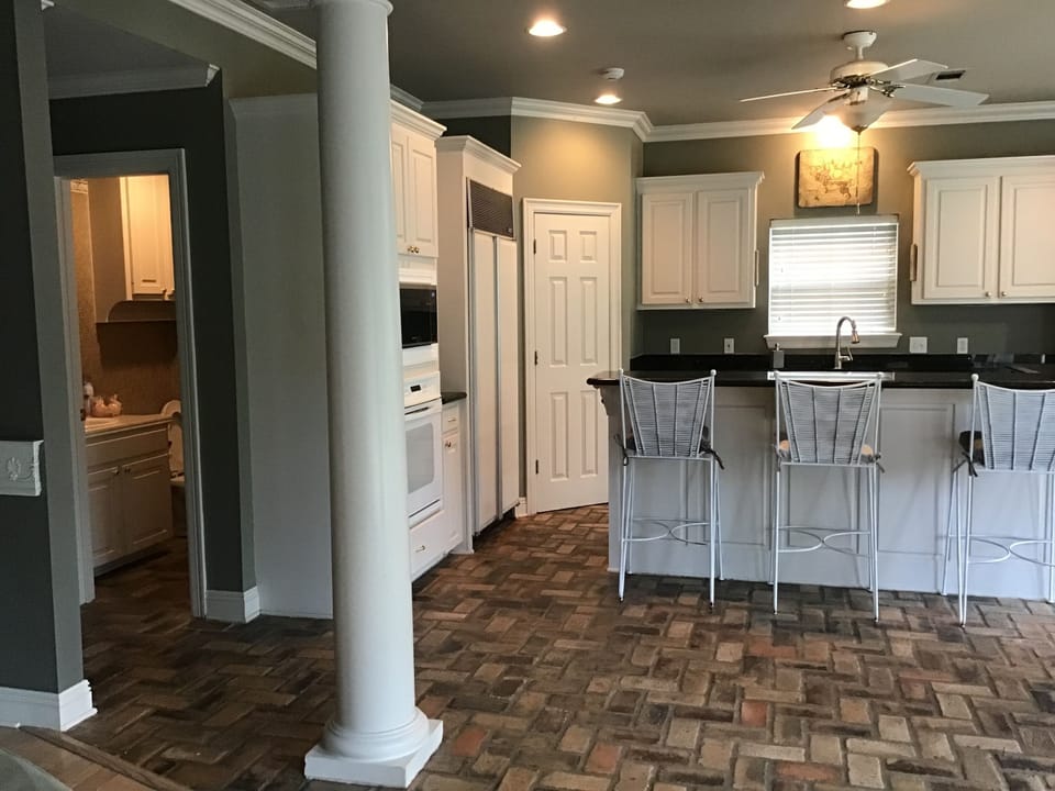 View of kitchen and restroom off den