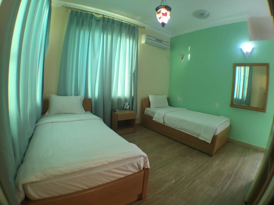Family Room | Minibar, WiFi (free), bed sheets