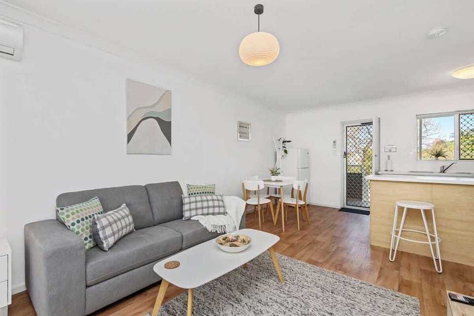 Enjoy seamless living in this charming space that combines a cozy lounge area with a practical dining spot and a glimpse of the kitchen.