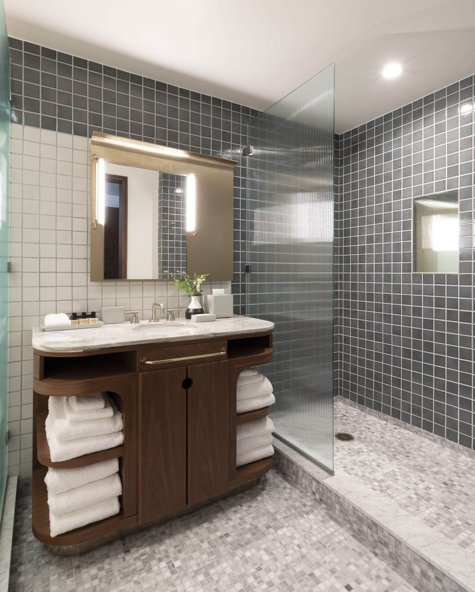 Shower, designer toiletries, hair dryer, bathrobes