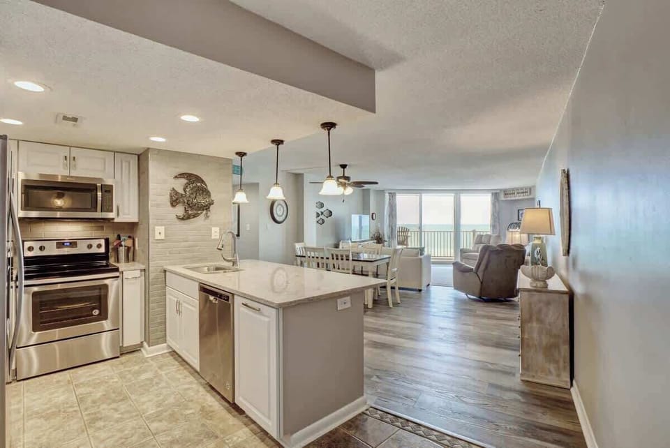 Relax in this stylish open-concept condo featuring a fully equipped kitchen, cozy dining area, and ocean-view living room — all just steps from the beach.