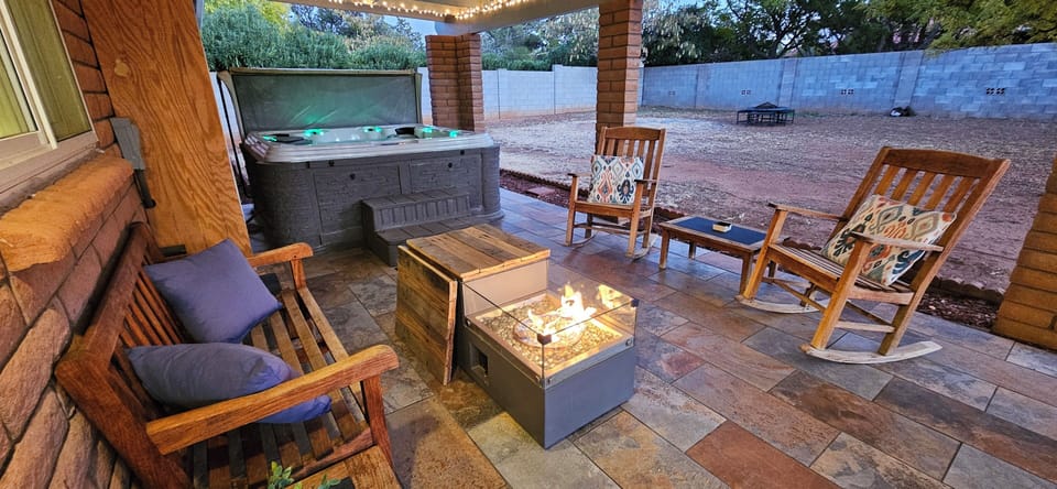 Patio with fireplace and hot tub
