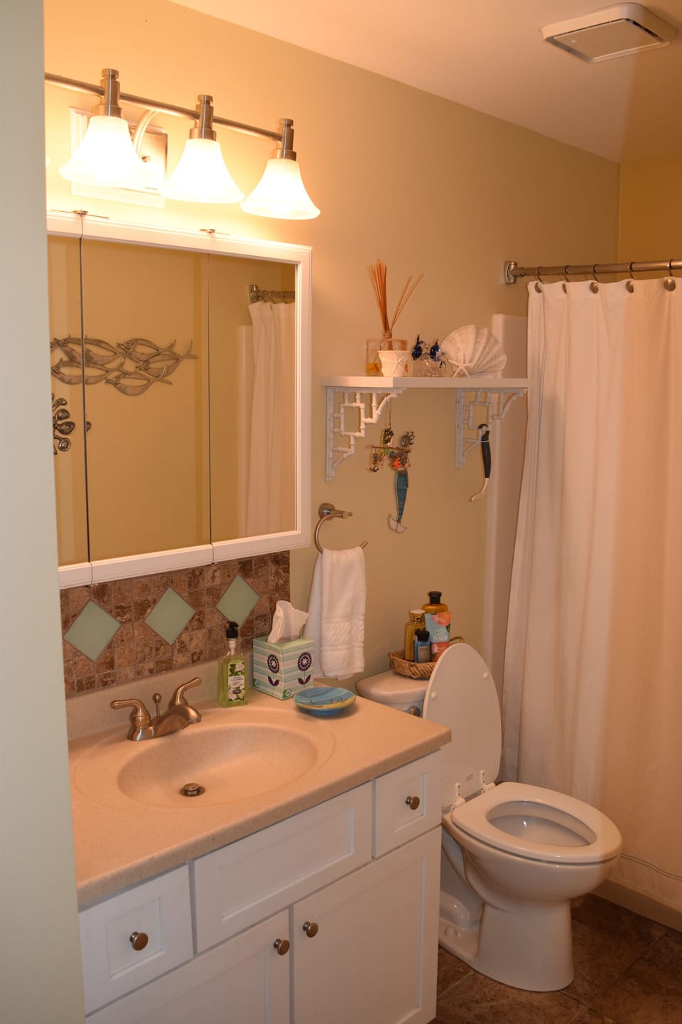 Modern bathroom with new tile and ocean inspired backsplash!