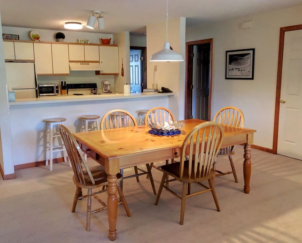 Clean and comfortable open-concept living space with dining table