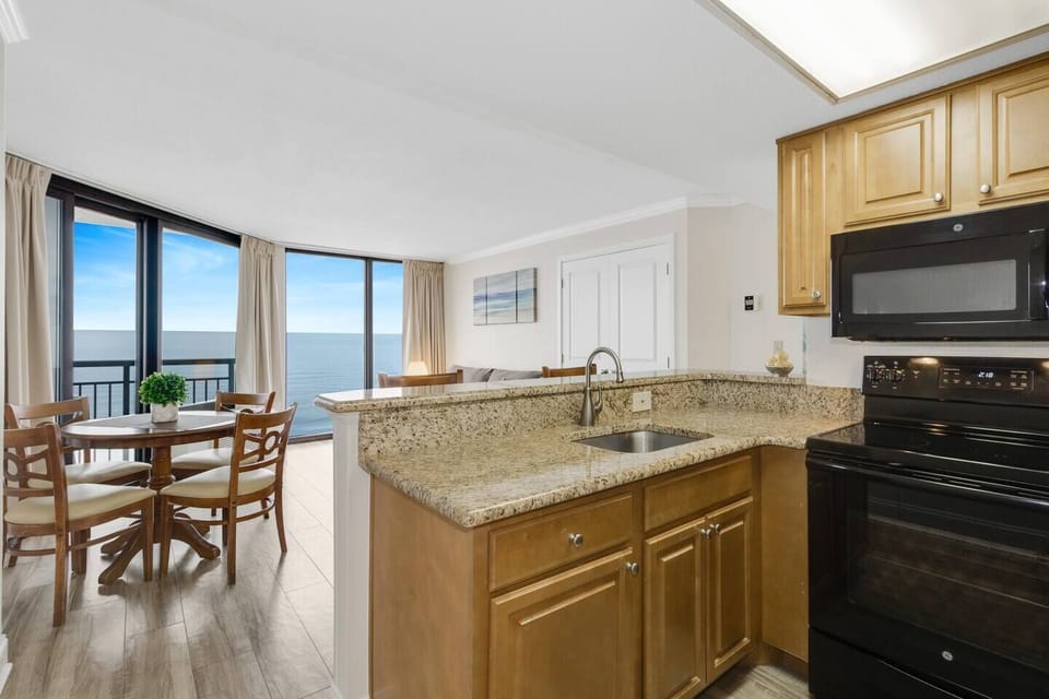 Discover modern elegance in every corner of our oceanview suite's kitchen, with high-end finishes, stainless steel appliances, and expansive windows framing the picturesque seascape.