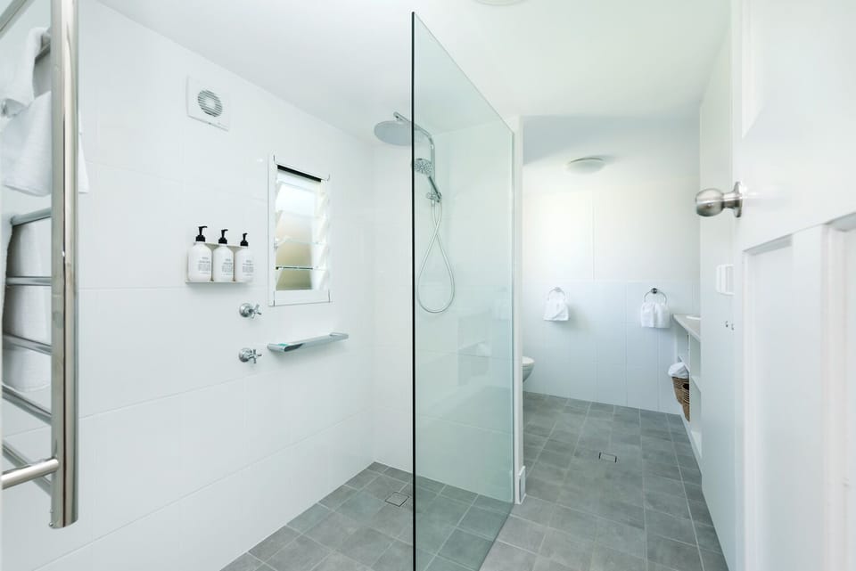 Bathroom with walk in shower, heated towel rails and euro laundry.