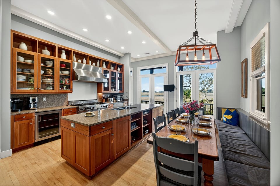 Gourmet kitchen with large dining table with half bench seating