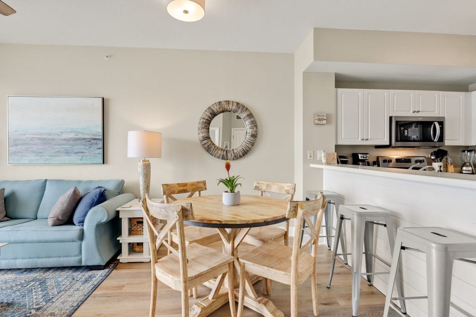 Cozy dining table with additional seating at the breakfast bar.