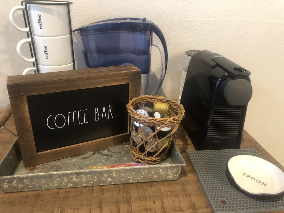 Stocked coffee bar with Keurig Coffee maker, coffee, creamer, etc. 
