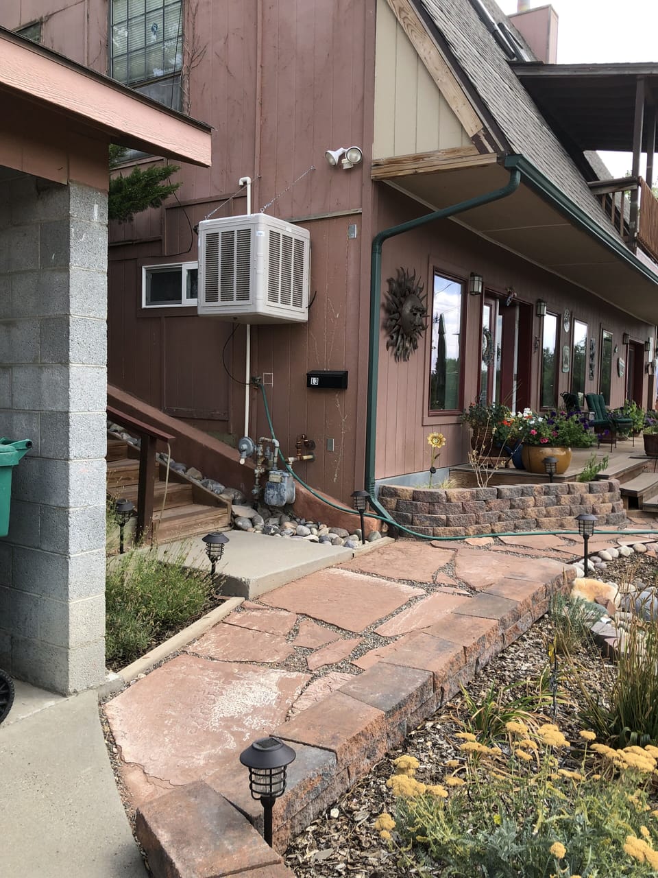 Stairs on side of the house lead to the private entrance. 