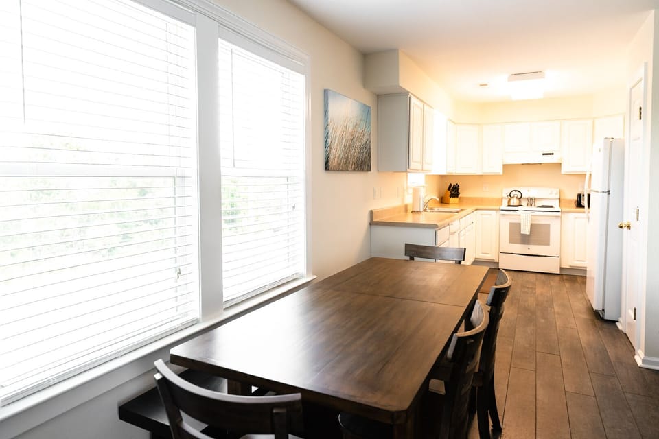 Dining room table with seating for six and fully equipped kitchen. 
