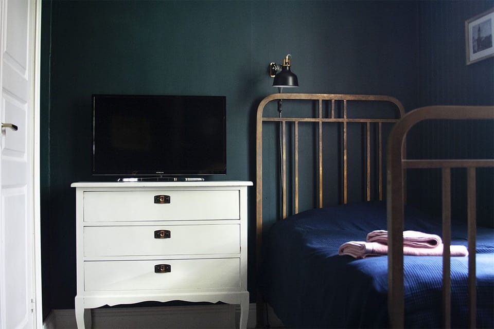 Desk, laptop workspace, blackout drapes, iron/ironing board