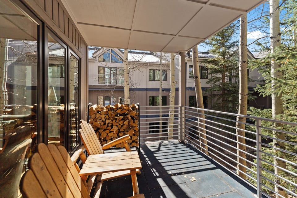 Step onto your private covered terrace and breathe in the fresh mountain air while relaxing on cozy wooden chairs.