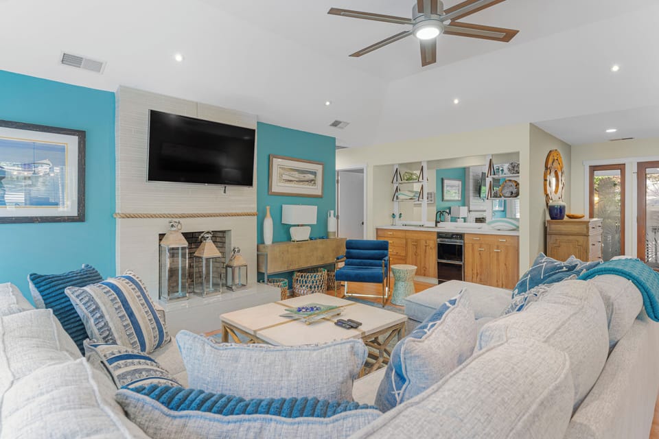 Great room with sitting and dining area, access to back deck and views of lagoon