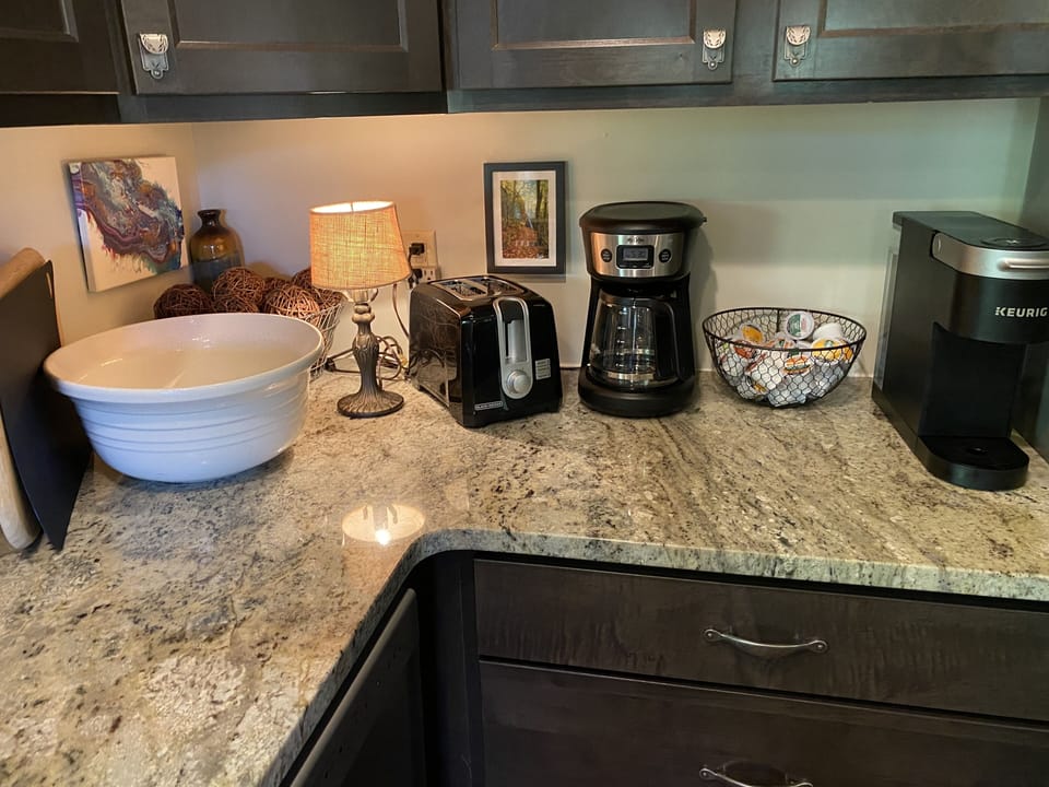 Coffee pot & Keurig with coffee & creamers provided.