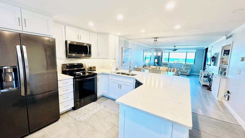 The fully-equipped kitchen has quartz countertops.