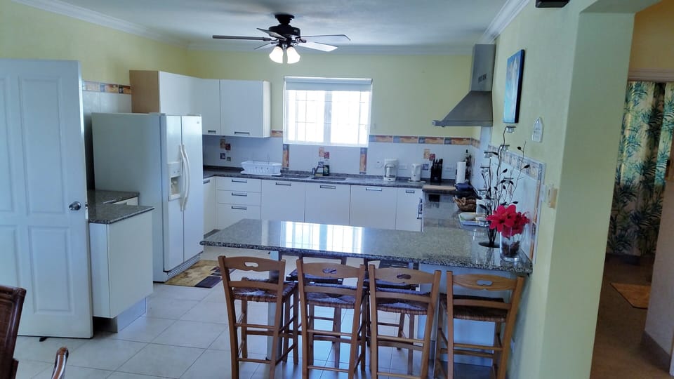 Well equipped kitchen with breakfast bar which can seat six 