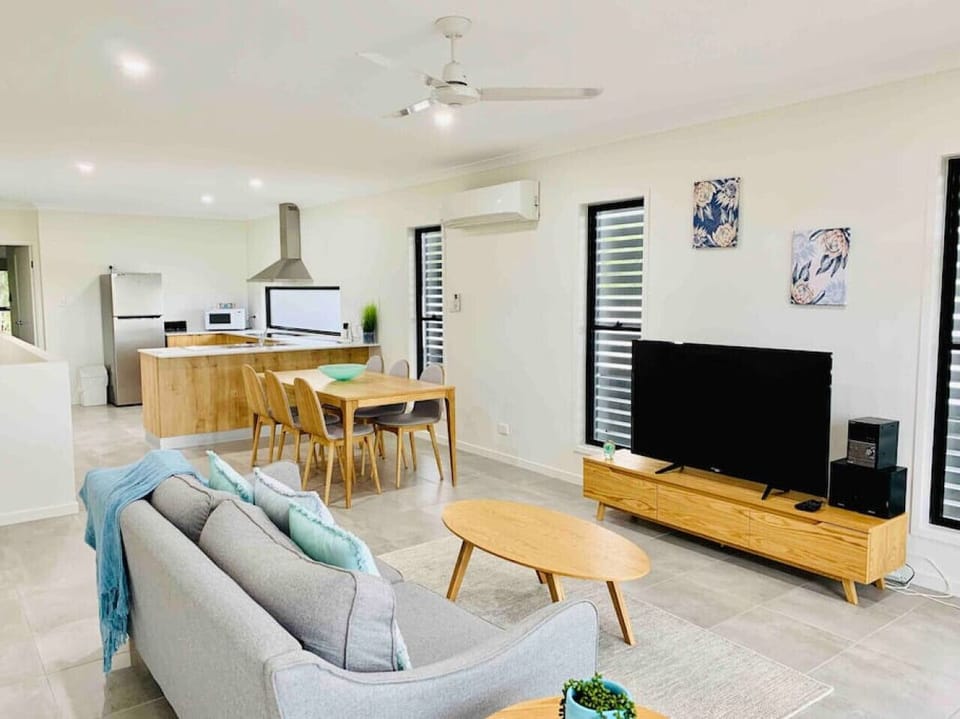 Large, bright and airy, open plan lounge, dining and kitchen area that opens onto the balcony with water views across Whisper Bay