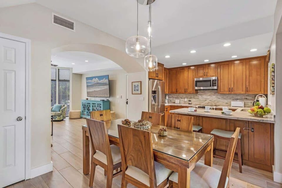 Gather with loved ones in this Maui retreat featuring a fully equipped kitchen and elegant dining area. Enjoy home-cooked meals, modern appliances, and open-concept design that flows seamlessly into the living room—perfect for relaxing after island a