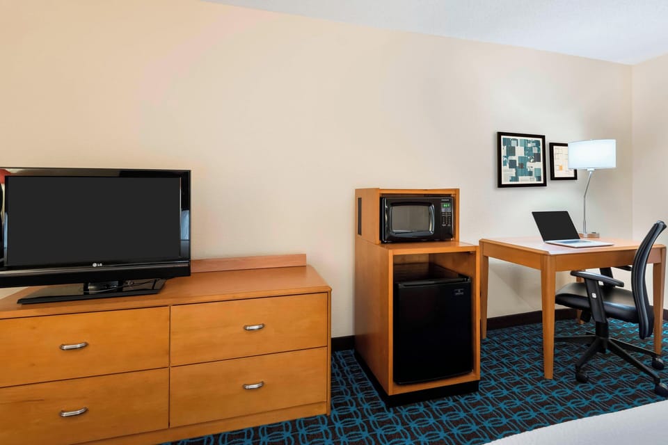 Desk, blackout drapes, iron/ironing board, bed sheets