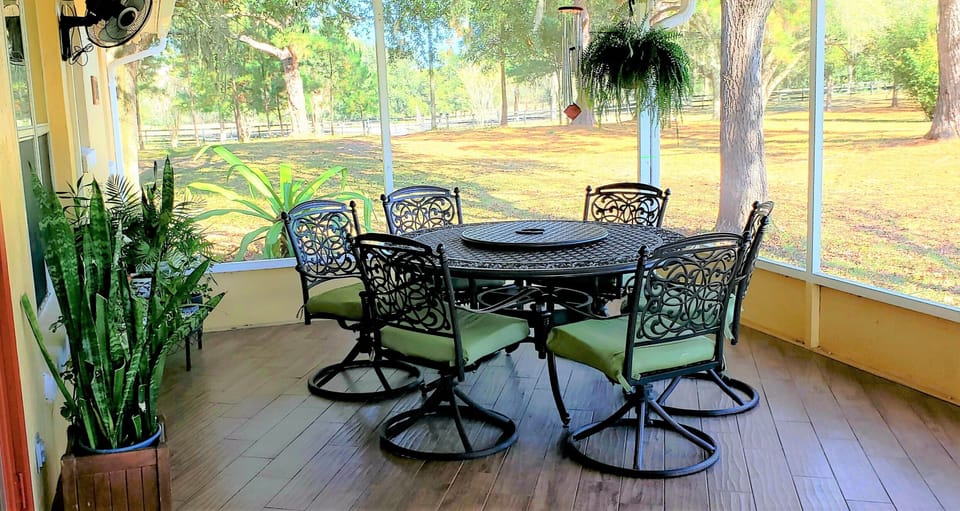 Huge Screened Porch with Wall Fans, table, chairs and Gas Grill