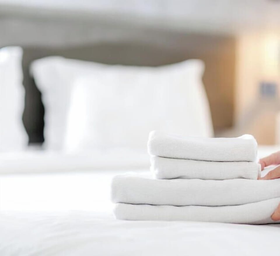 Freshly laundered towels and perfectly made beds await your arrival—soft, welcoming, and ready for your coastal escape.