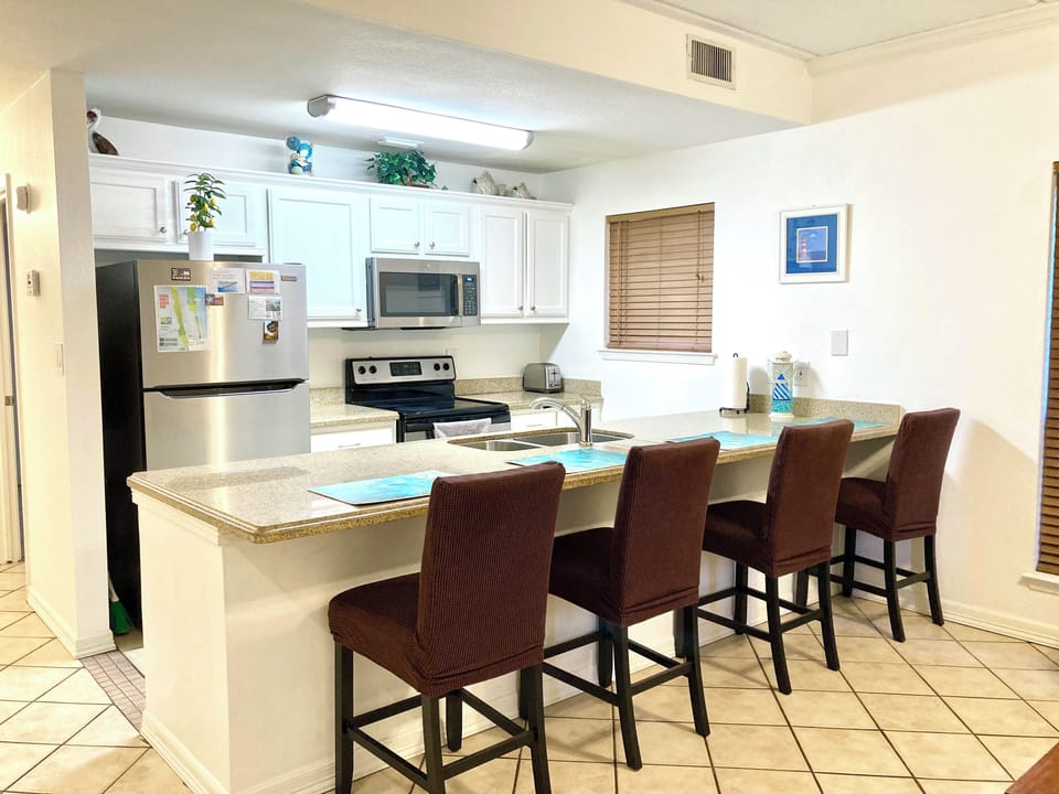 Open Spacious Floor Plan - Kitchen with Dining Bar and Family Room.