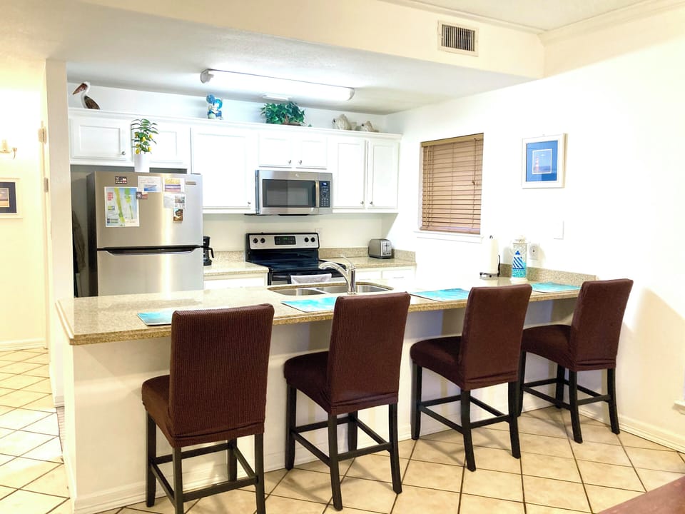 Open Spacious Floor Plan - Kitchen with Dining Bar and Family Room.