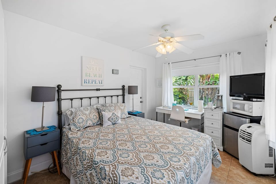 Bedroom with queen bed and work space.