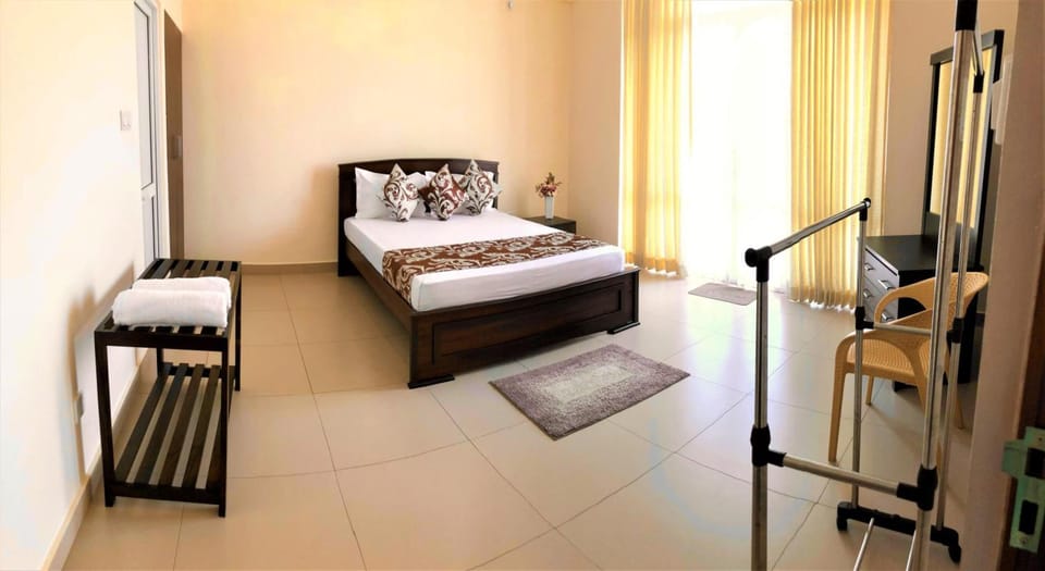 Desk, iron/ironing board, bed sheets