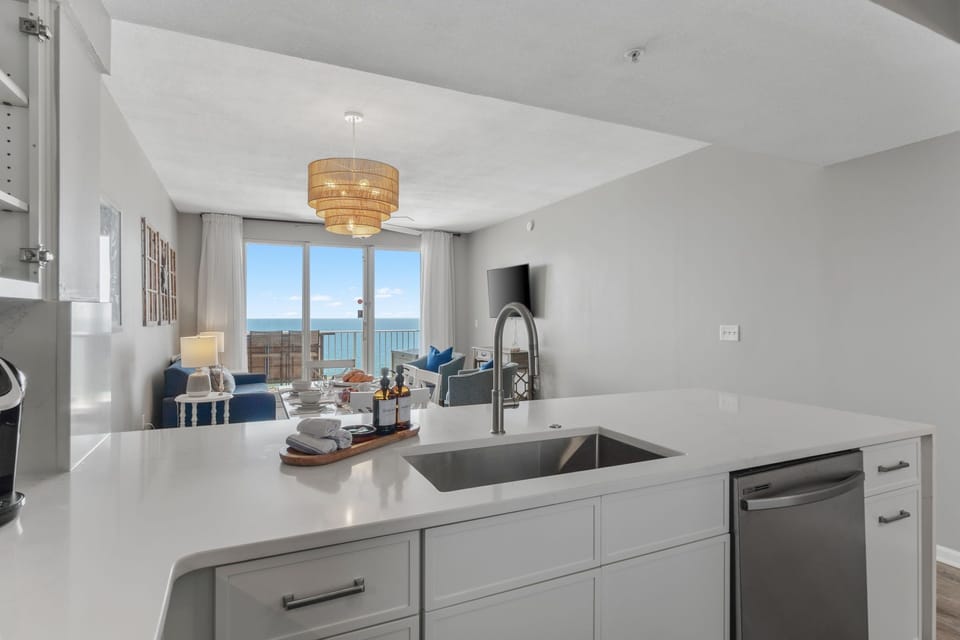 Beachfront condo with open living + dining—seamless views, sunlit vibes.