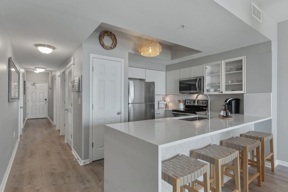 Updated kitchen with quartz, backsplash & pantry—function meets coastal style.