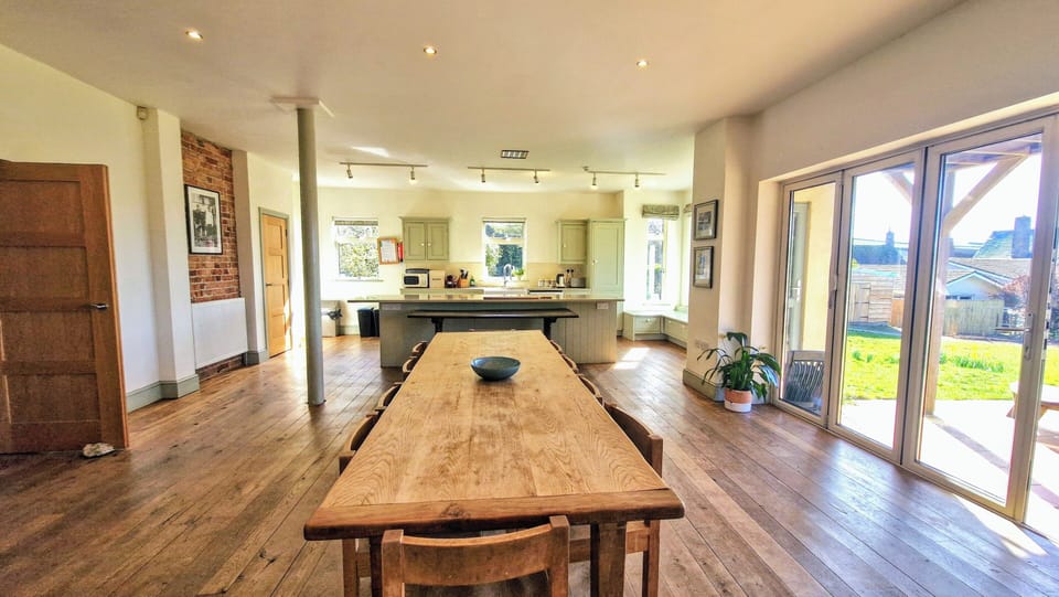 Large farmhouse dining table with direct access on to the sunny garden patio
