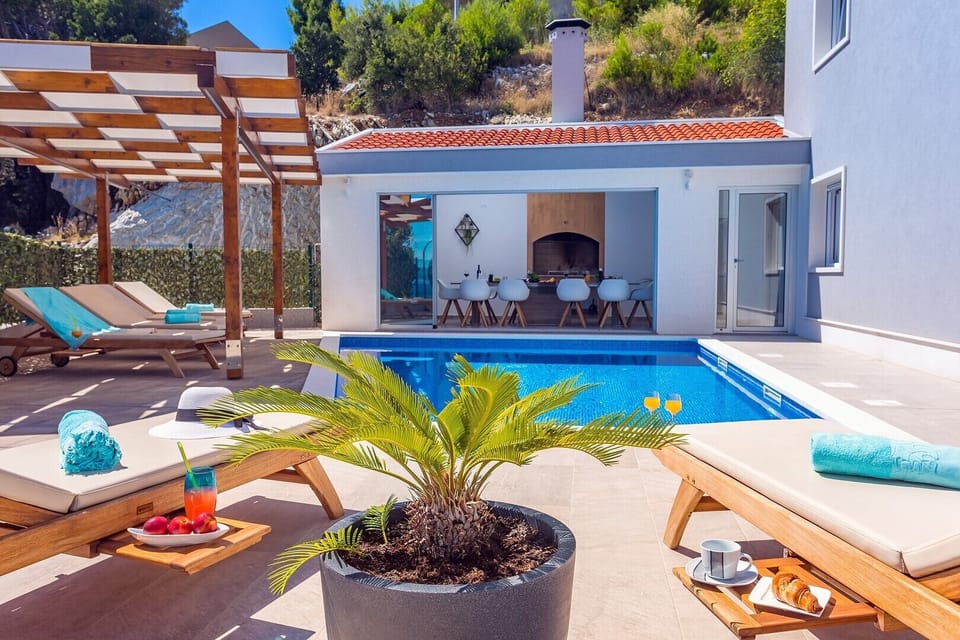 Private pool and pool area connected with summer kitchen