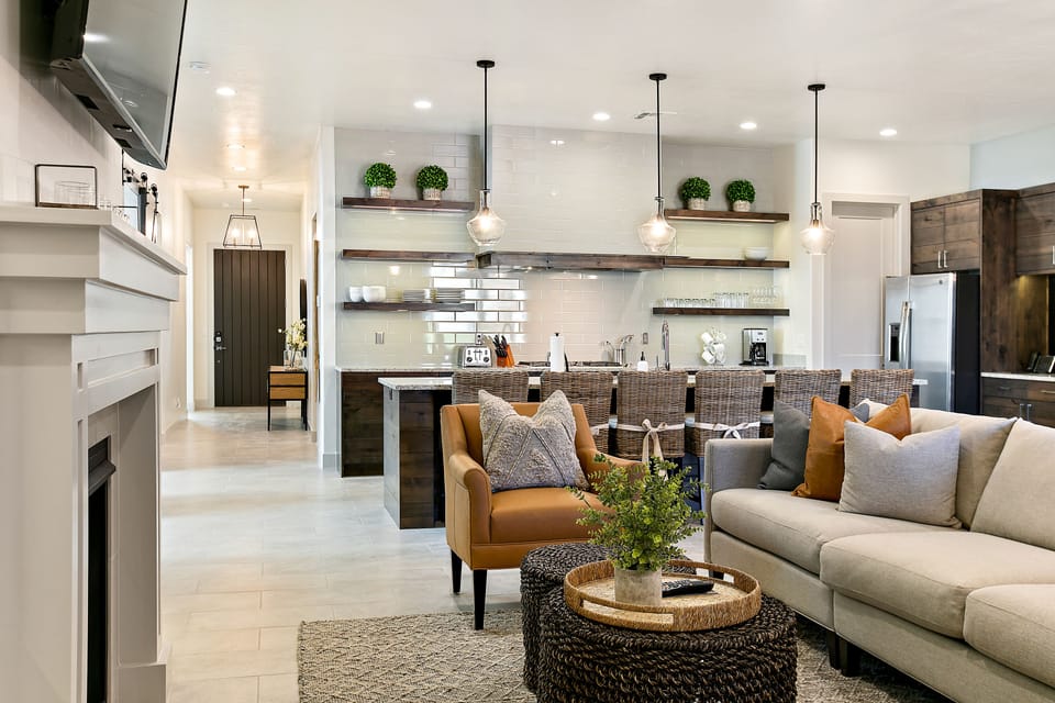 Main floor living room with sofa/chair seating, a smart TV, and a fireplace