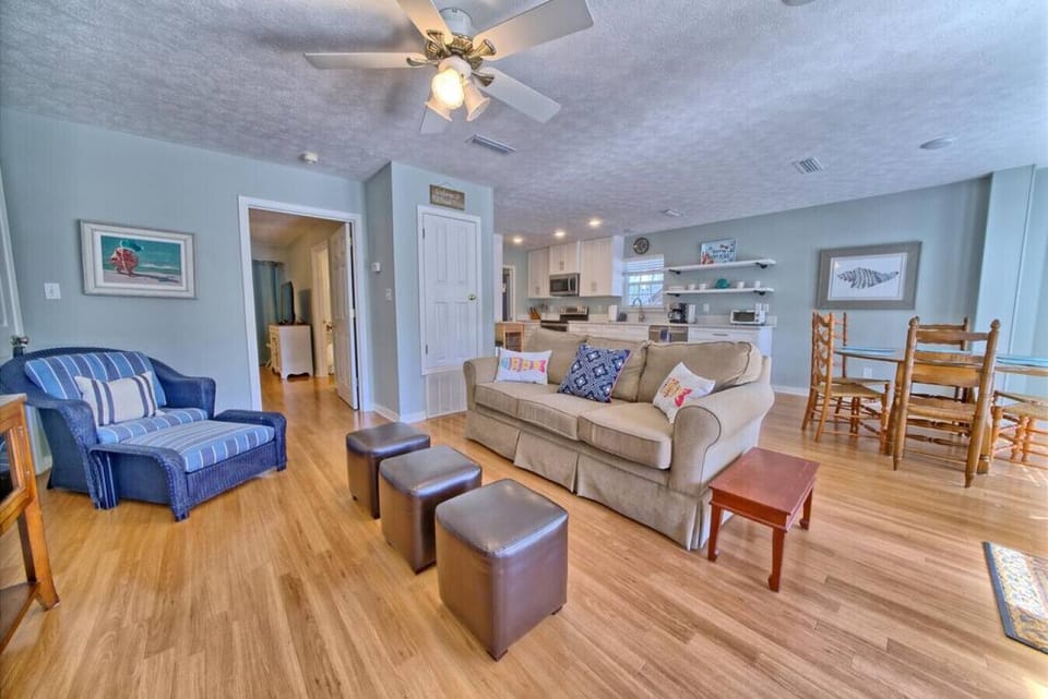 Open-concept living meets cozy charm in this inviting space, perfect for unwinding or enjoying meals with loved ones