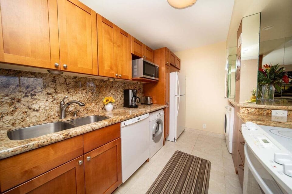 Cook and clean with ease in kitchens paired with laundry nooks.