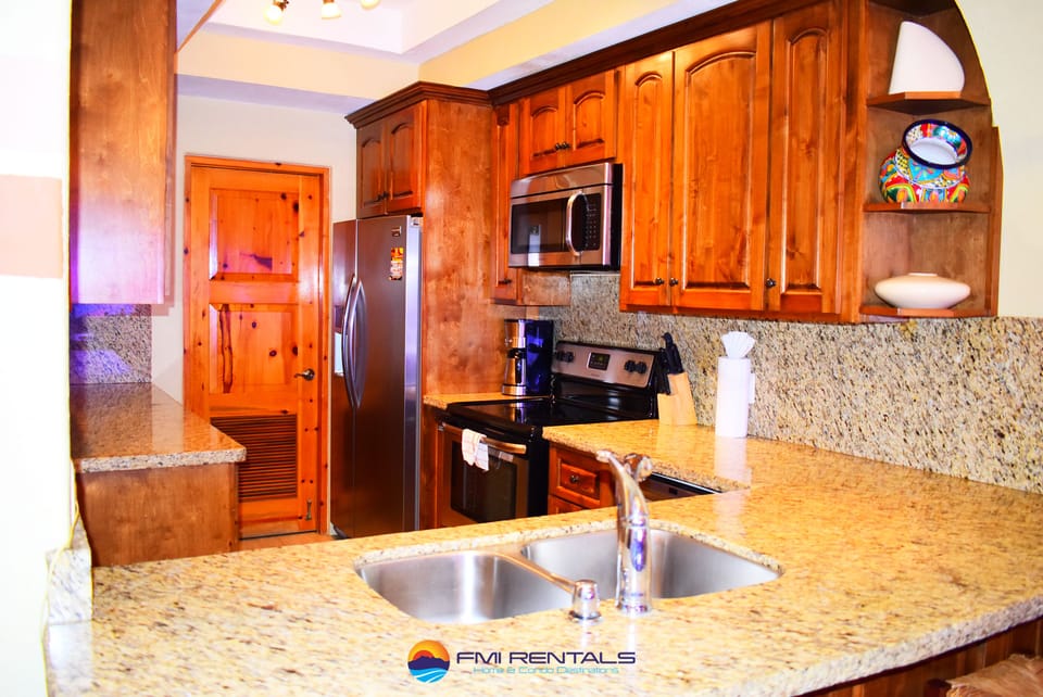 luxury kitchen with alder cabinets, granite counters, and stainless steel appliances