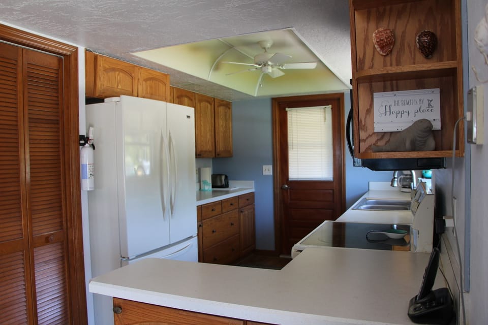 Spacious kitchen fully stocked: dishes, pots, pans, utensils, & spices. 