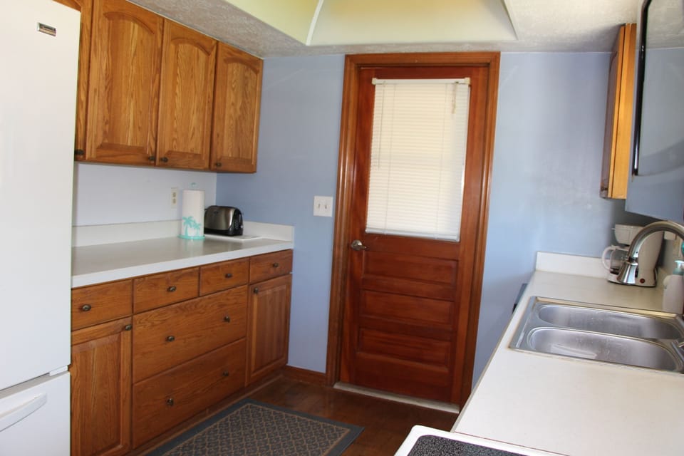Spacious kitchen fully stocked: dishes, pots, pans, utensils, & spices.