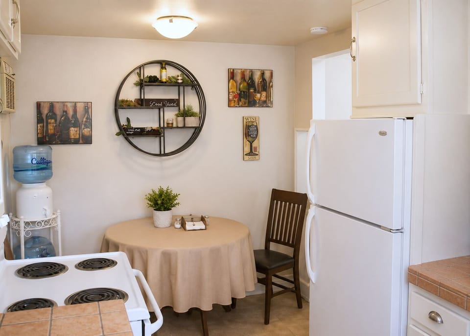 Gather at the round table beside the compact kitchen.