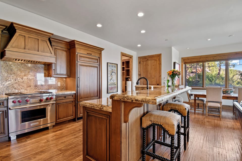 Kitchen looking over to dining table with large windows and views