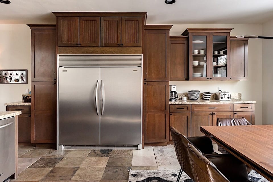 Large, French Door, Built-in refrigerator and ample cabinetry for a fully equipped culinary setup.