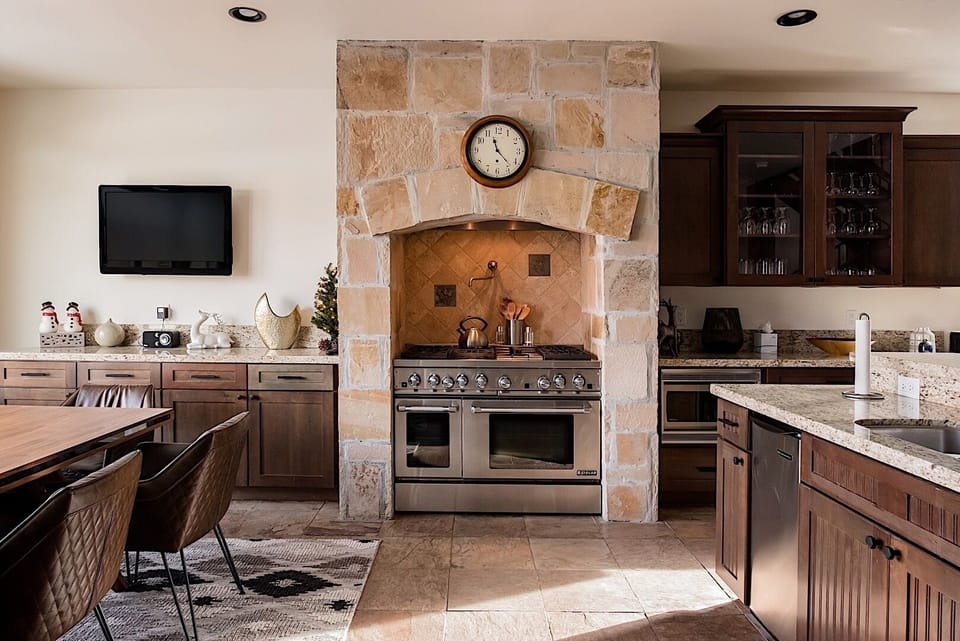 Warm stonework, custom finishes, and inviting gathering spaces create a welcoming atmosphere throughout the home.
