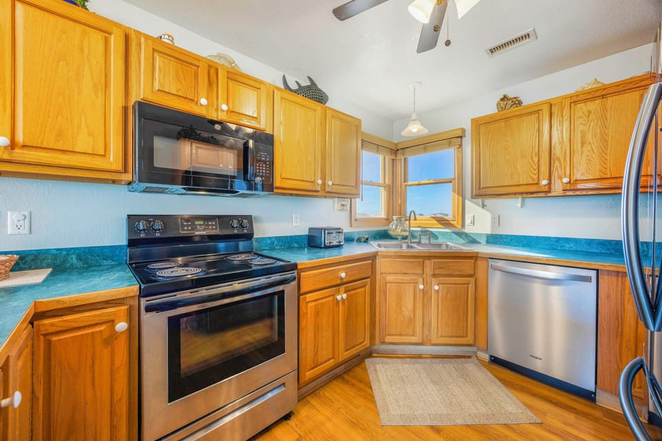 Your fully-equipped kitchen features warm oak cabinets, modern stainless steel appliances, and everything you need to prepare delicious home-cooked meals.