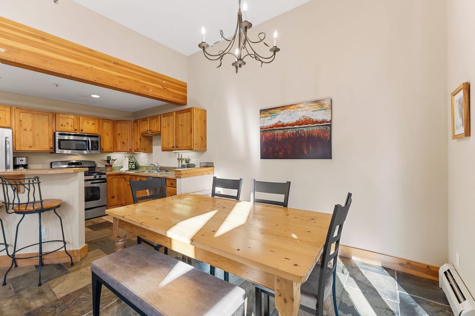 Gather around your spacious dining table where warm wood tones and elegant lighting create the perfect setting for memorable meals together.